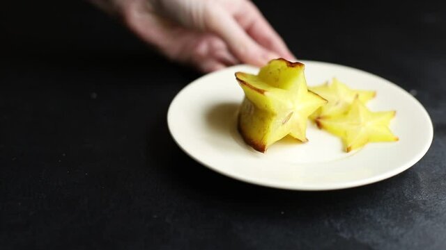 carambola star fruit cut into slices on the table for healthy meal snack outdoor top view copy space for text food background rustic