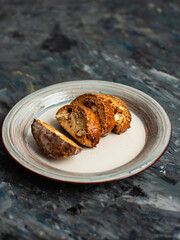 Italian cookies. Macaroons on a plate on a dark background. Fitness food Rustic style.