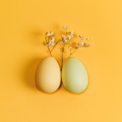 Creative flat lay photo of easter eggs on colorful background.