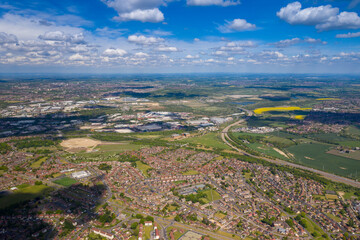 Aerial photo of a typical British housing estate in the village of Middleton in Leeds West Yorkshire in the UK, showing a top down drone view of suburban streets, roads and rows of houses.