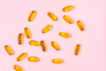 Fish oil on light pink background.