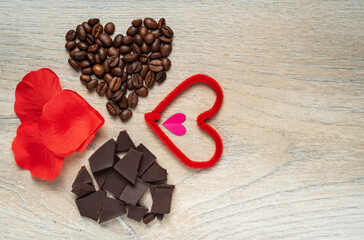 Valentine's day gift with a lot of hearts, coffee, chocolate and love. Placed on a wooden background.