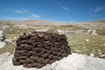 Pile of peat drying in the sun on the Isle of Harris