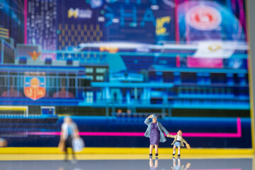 Miniature people : Grandma and grandson stand behind the scene of technology city