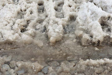 Tire and foot tracks on dirty snow, Anti-icing chemicals