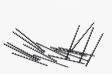 Many black plastic straws on white. Recycle, environment conversation, pollution and plastic straw ban concept. Abstract background, copy space