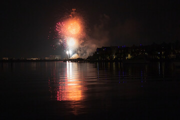 Naklejka na ściany i meble Fireworks reflecting in water