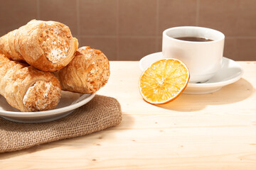 composition of Fresh cream puff cones, coffee and marshmallows. Coffee flavor for breakfast