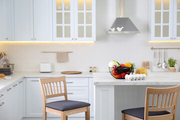 Modern kitchen interior with different products on white table