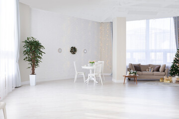Luxurious and expensive interior of an open-plan apartment in light colors. Stylish modern bedroom with minimal design, dining area and guest space.