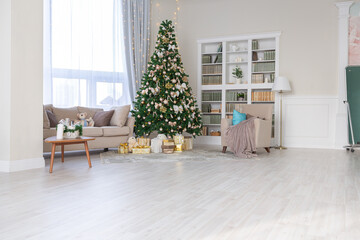 Luxury rich expensive apartment interior in light colors. Stylish contemporary minimalistic design. Full of sun light. A lot of space decorated with Christmas tree