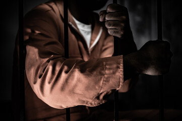 Asian man desperate at the iron prison,prisoner concept,thailand people,Hope to be free,Serious prisoners imprisoned in the prison