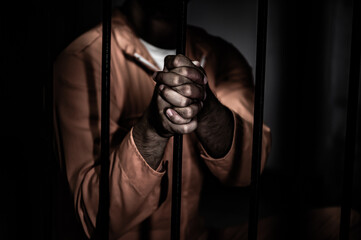 Asian man desperate at the iron prison,prisoner concept,thailand people,Hope to be free,Serious...