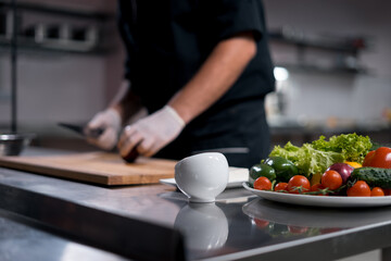 chef cook in medical gloves prepare greek salad or chop vegetables at kitchen 