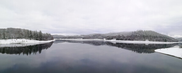 landscape of winte lake, forest and snow covered mountains