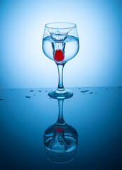 Colored ice ball droped into coctail glass .
