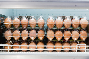Eggs in transparent packages on shelf in supermarket