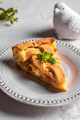 Homemade apple pie with mint leaves on a plate
