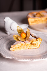 Homemade apple pie with fisalis on a plate