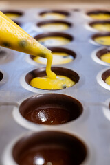 pouring the filling into candies during the manufacturing process
