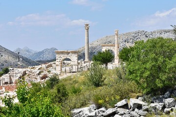 Fototapeta na wymiar Marble ach and columns in Sagalassos Ancient City, Burdur, Turkey. Ruins of the ancient Roman city of Sagalassos.
