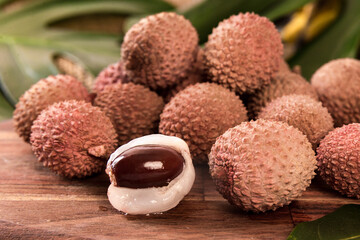 fresh organic lychee fruit on bamboo basket and old wood background, Blurred background selective focus