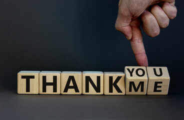 Thank you or me symbol. Businessman turns cubes and changes words 'thank me' to 'thank you'....