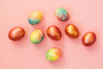 Painted Easter eggs on a pink background.
