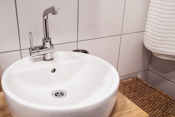 Modern sinks with a mirror in a public toilet. Bachelor's reflection in the mirrors.