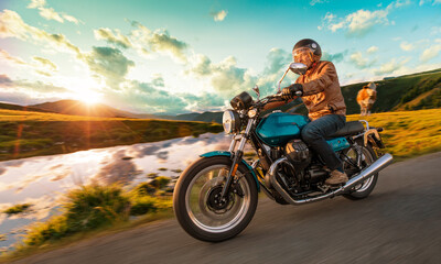 Fototapeta na wymiar Motorcycle driver riding in Alpine route in Europe.