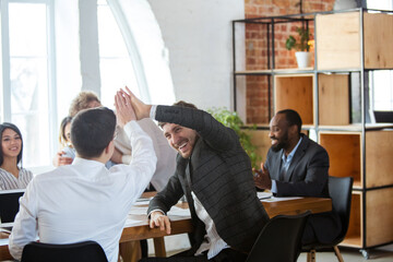 Teamwork. Diverse group of co-workers having casual discussion in office. Executives during friendly discussion, month reporting, creative meeting. Concept of business, finance, occupation, job.