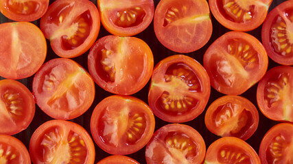 Cherry tomatoes. Slices on a black background