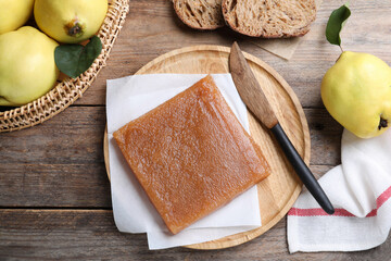 Delicious quince paste and fresh fruits on wooden table, flat lay
