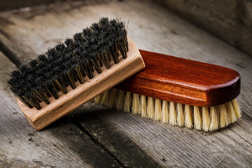 Accessories for the care and cleaning of shoes on a wooden table