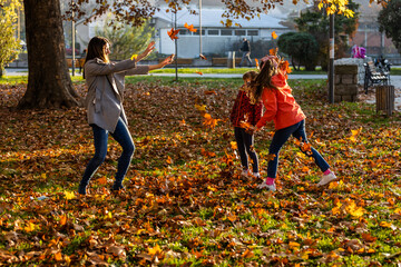 A mother and her daughters enjoy the autumn game