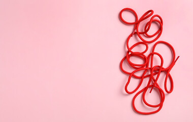 Red shoelaces on pink background, flat lay. Space for text - obrazy, fototapety, plakaty