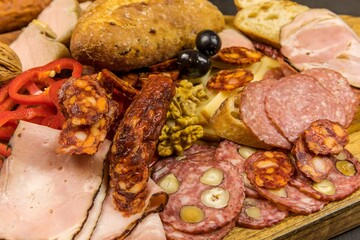 Various kind types of salami, speck and sausages on a wooden table. Fat junk food. Smoked meat. Obesity concept. Overweight.