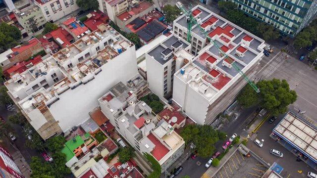 Aerial Orbit of Apartment Buildings with Green Construction Crane in Mexico City