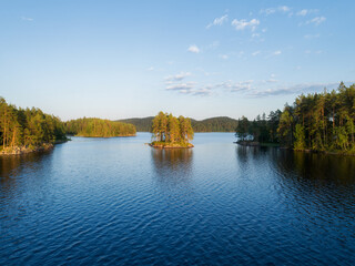 Fototapeta na wymiar Aerial panoramic view of beautiful calm lake at sunset surrounded by forests. Isojarvi National park, Finland