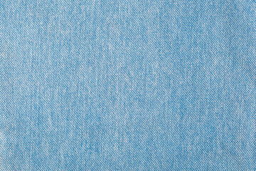 Background from light blue denim.Textile jeans.Selective focus.Concept of tеxture decoration,design,covers,albums.