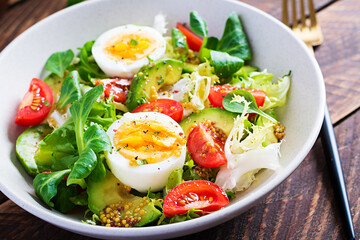 Fresh avocado salad with tomato, avocado, boiled eggs and fresh lettuce. Ketogenic diet breakfast.  Keto, paleo salad.