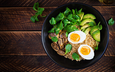 Breakfast oatmeal porridge with boiled egg, avocado and fried mushrooms. Healthy balanced food. Top view, above, copy space