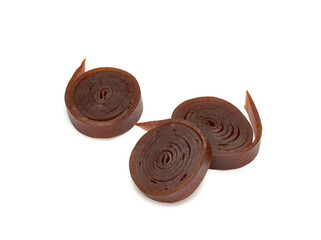 Fruit rolls pastille. Fruit candy rolls. Shredded and dried fruits. White background.