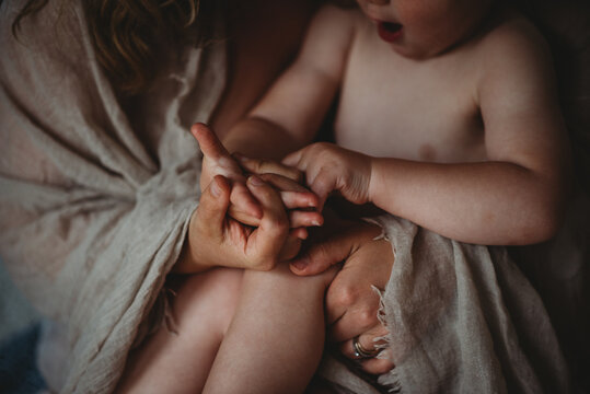 Close up of hands together of mother and child