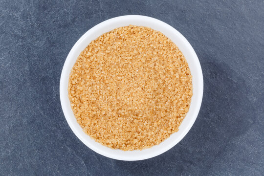 Brown Cane Sugar From Above Bowl On A Slate