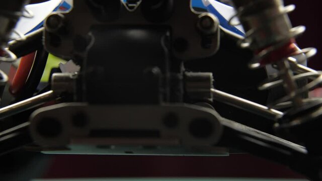 Close-up of radio control model suspension elements buggy car on cutting mat