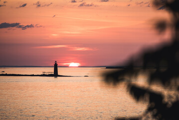 Sunrise over an island lighthouse off the coast of Maine