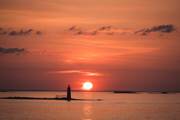 Sunrise over an island lighthouse off the coast of Maine