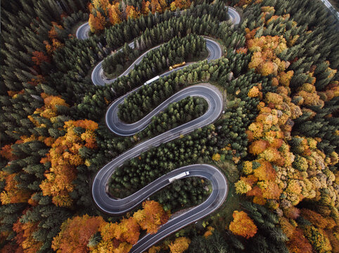 Aerial View of Epic Winding Road and Cars During Autumn