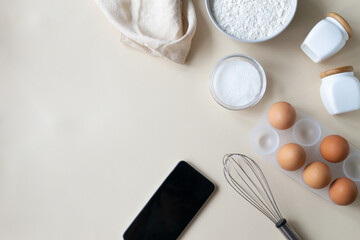 Online cooking courses. The smartphone is among the ingredients for cooking. Top view. Copy space.
